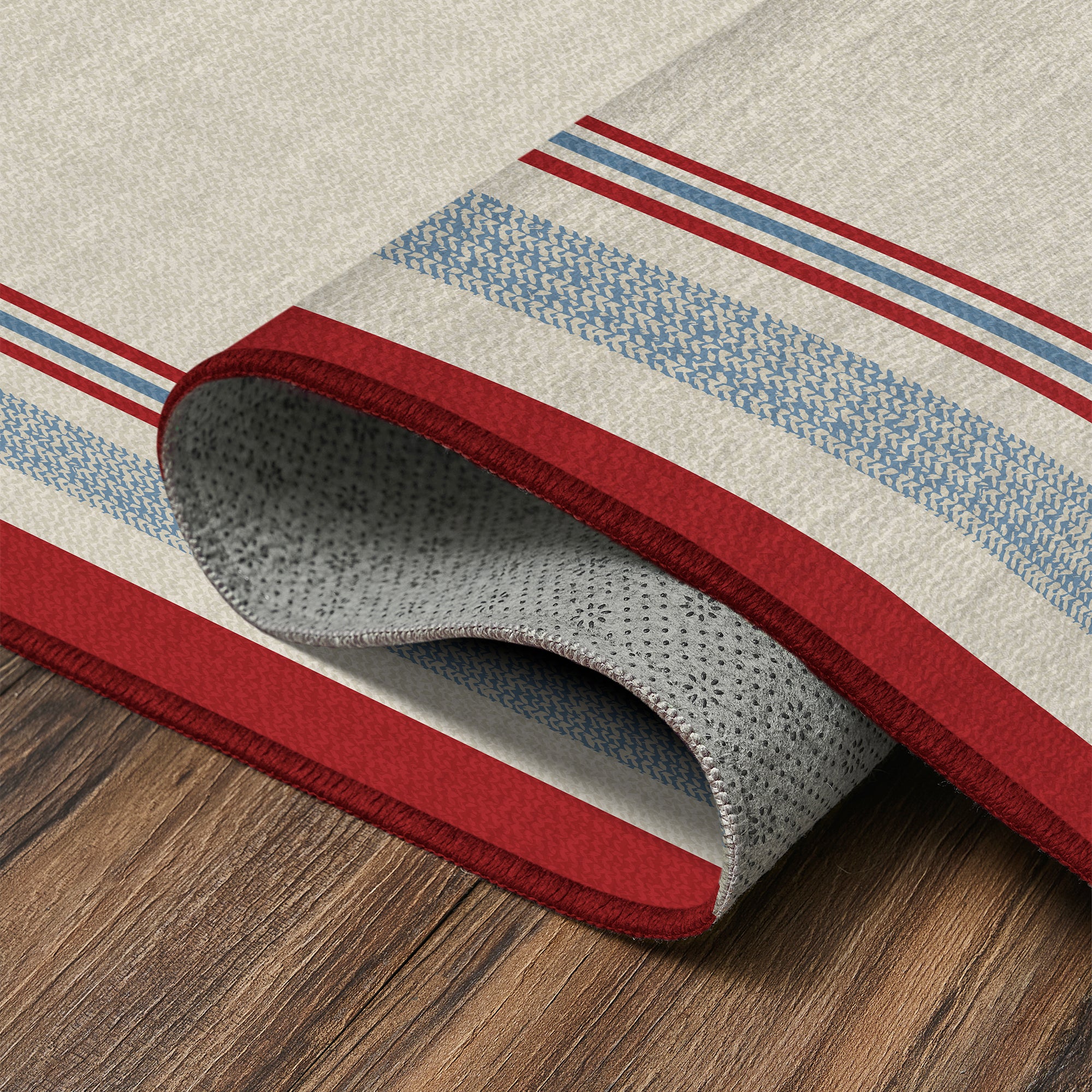 Kennedy bordered washable area rug with red and blue stripe frame on ivory base designed for living rooms, bedrooms, and hallways with non slip backing.